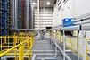 Inbound tote on the upper tier of conveying system to the allocated slot.