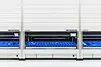 Three persons work on the six SSI LOGIMAT Vertical Lift Modules